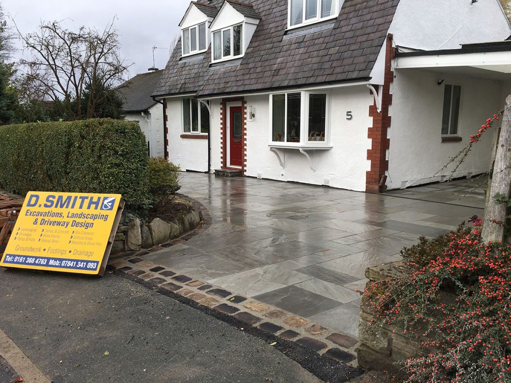 Natural stone driveway with cobblestone border