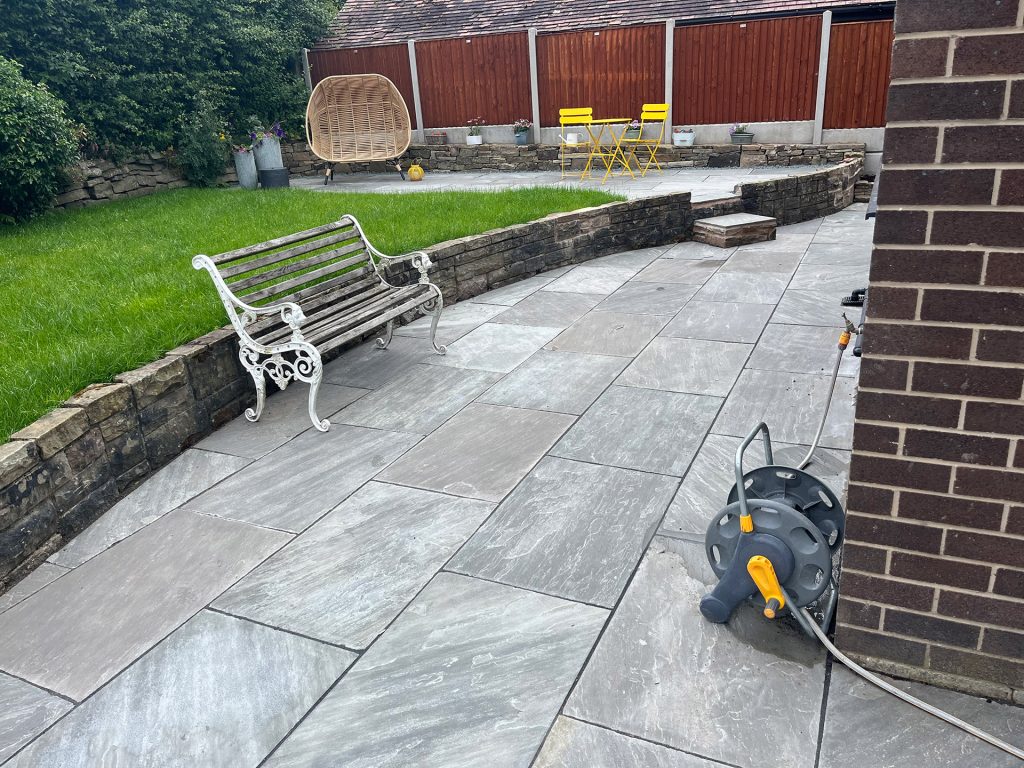Stone patio terrace area with step