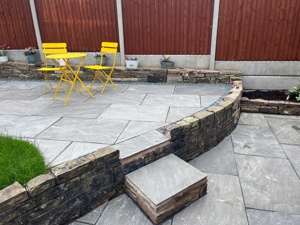 Stone patio terrace area with step