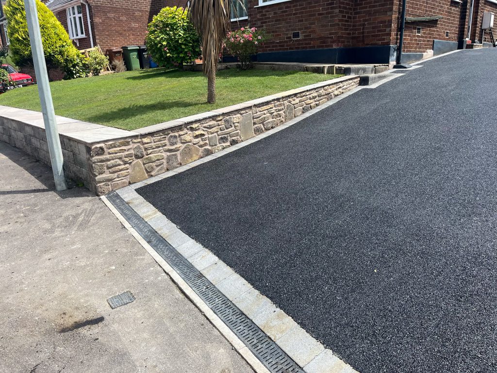 Stone retaining wall, landscaped grass and re-turfed garden
