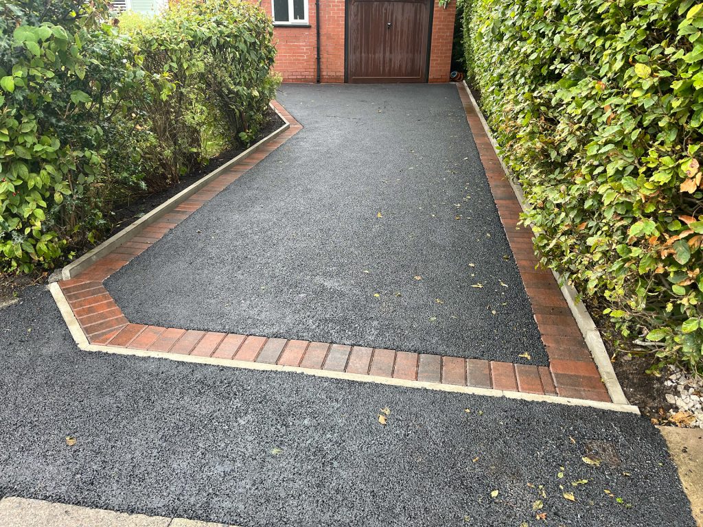 Tarmac driveway and red brick border