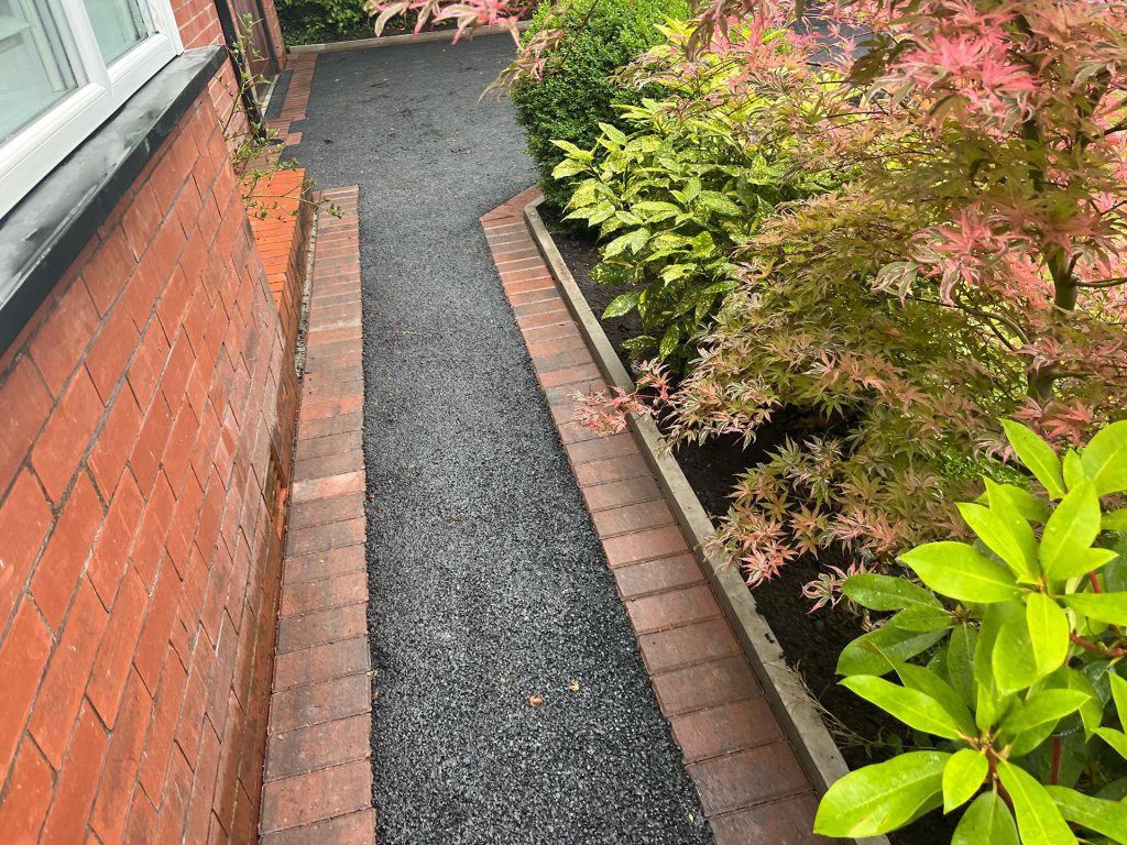 Tarmac pathway with red brick border