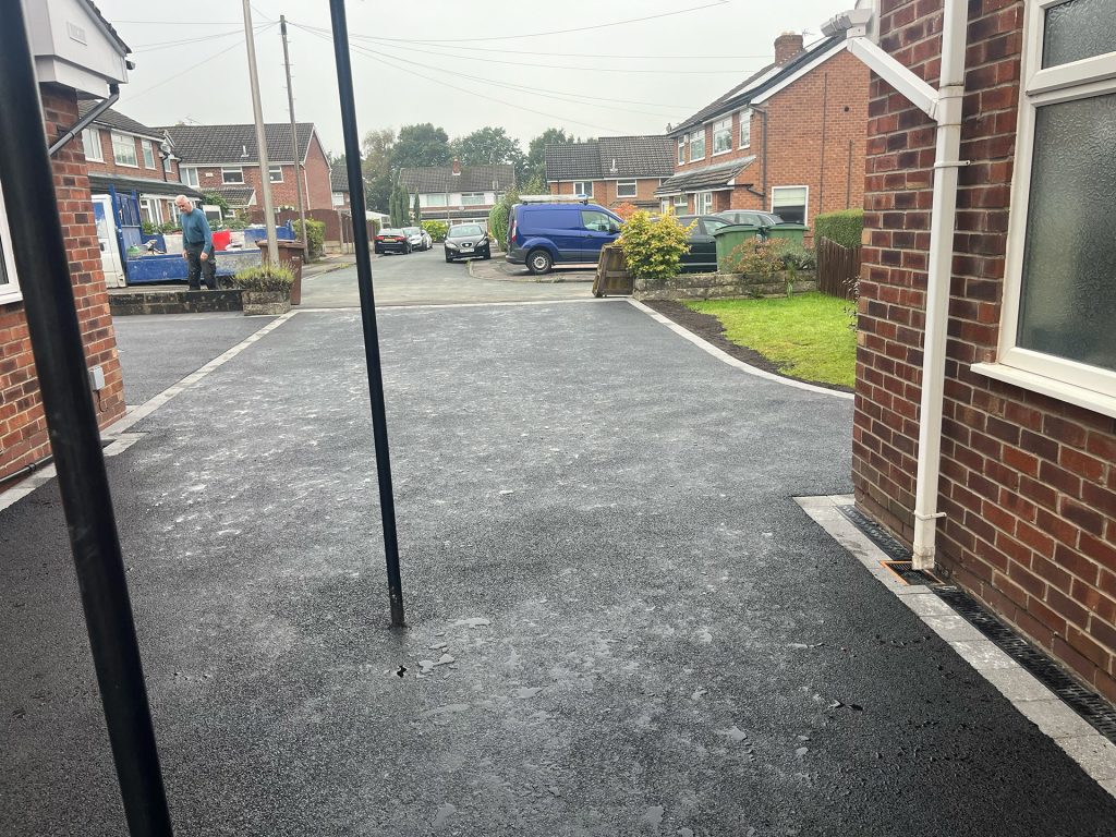 Tarmac driveway with block paved border, including underneath car port