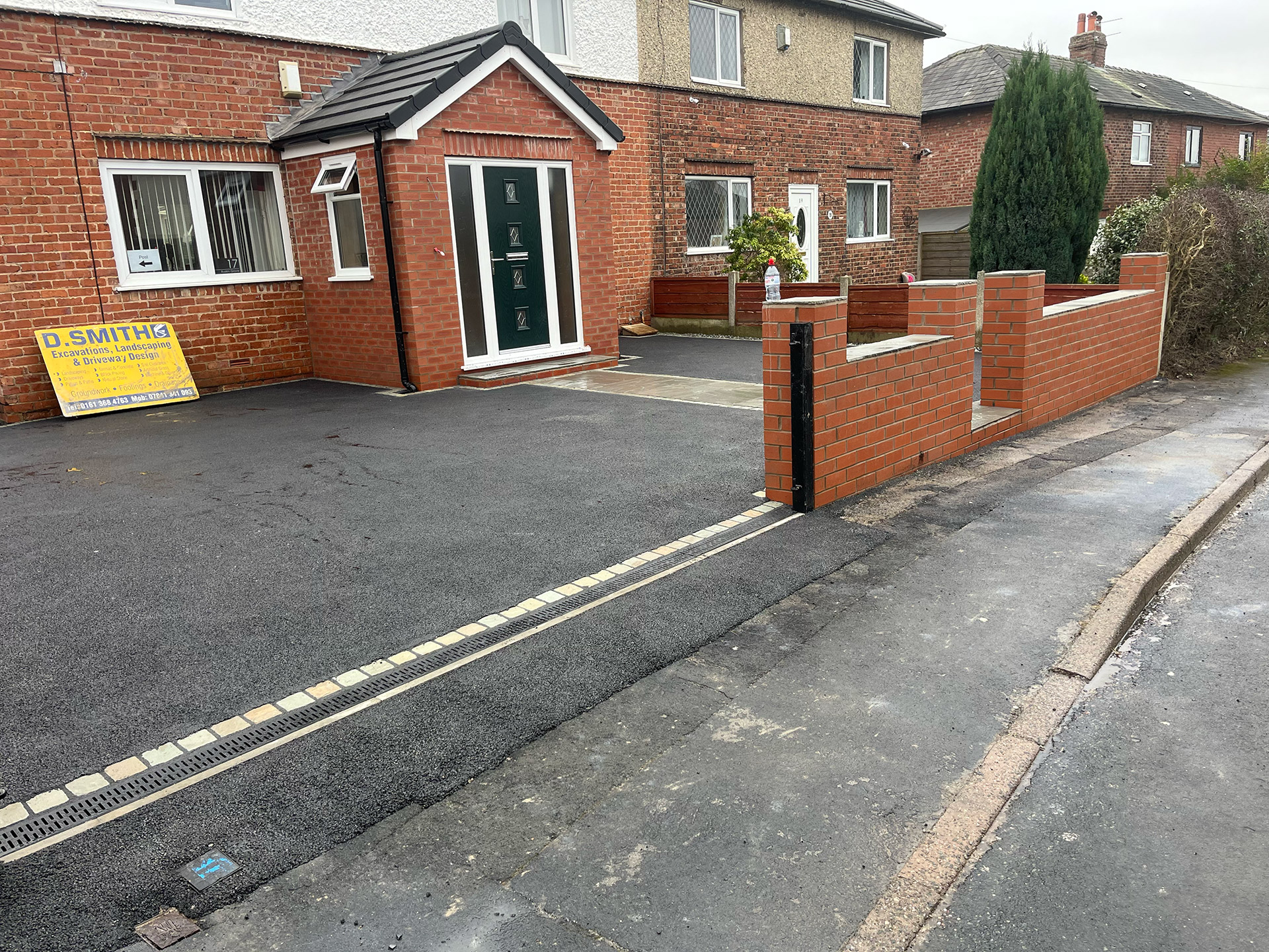Red brick boundary wall, tarmac driveway, Indian stone pathway Red brick boundary wall, tarmac driveway, Indian stone pathway