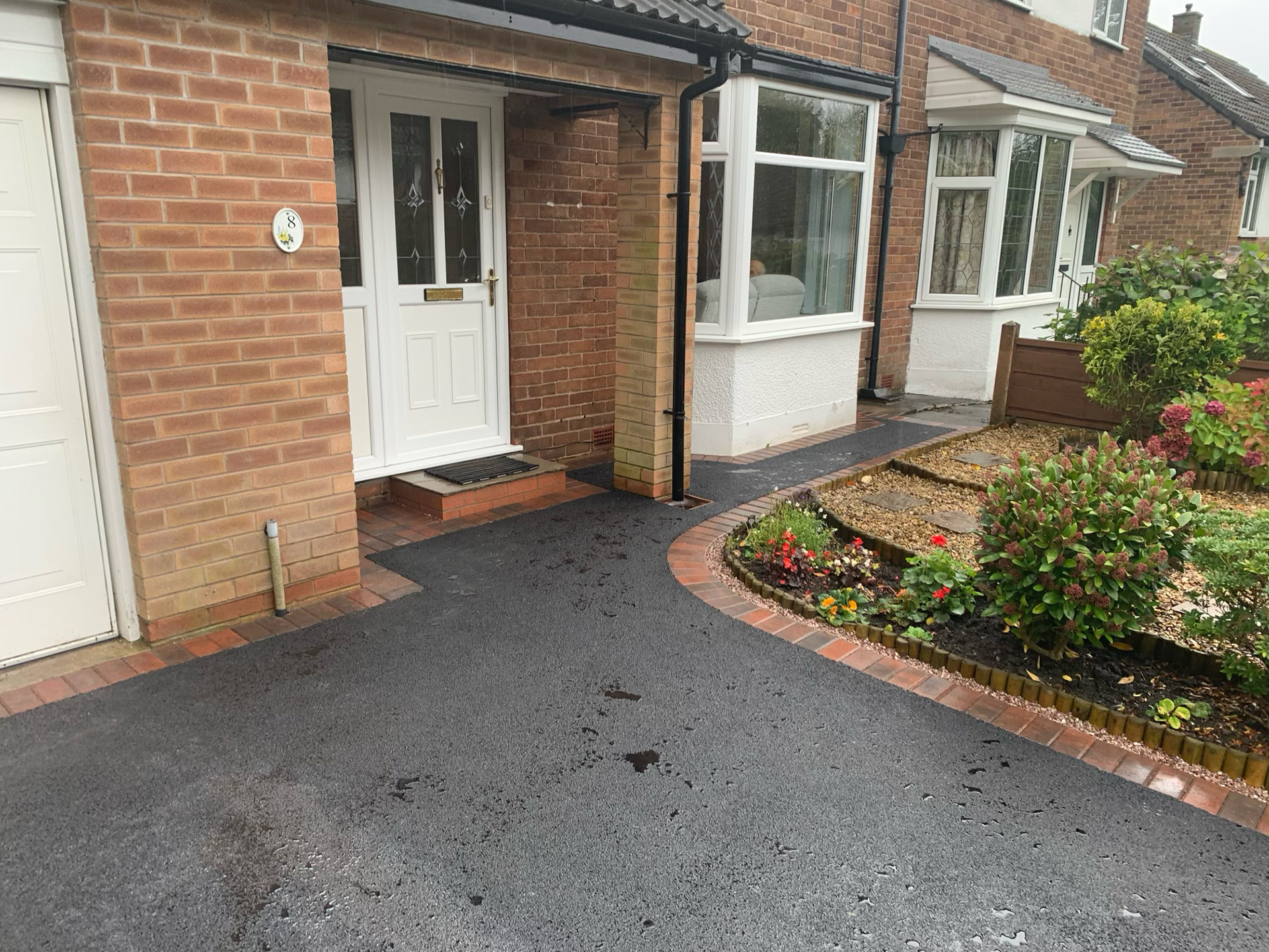 Tarmac home entrance Tarmac driveway front door entrance image with a block paved border,