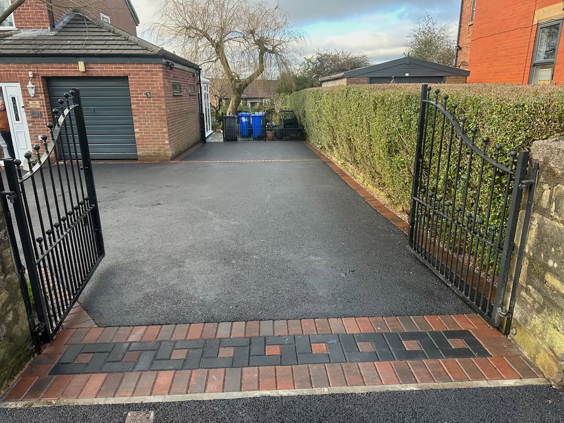 New tarmac driveway with block paved border, including a patterned threshold Cheetham Hill Road in Dukinfield, Tameside. New tarmac driveway with block paved border, including a patterned threshold